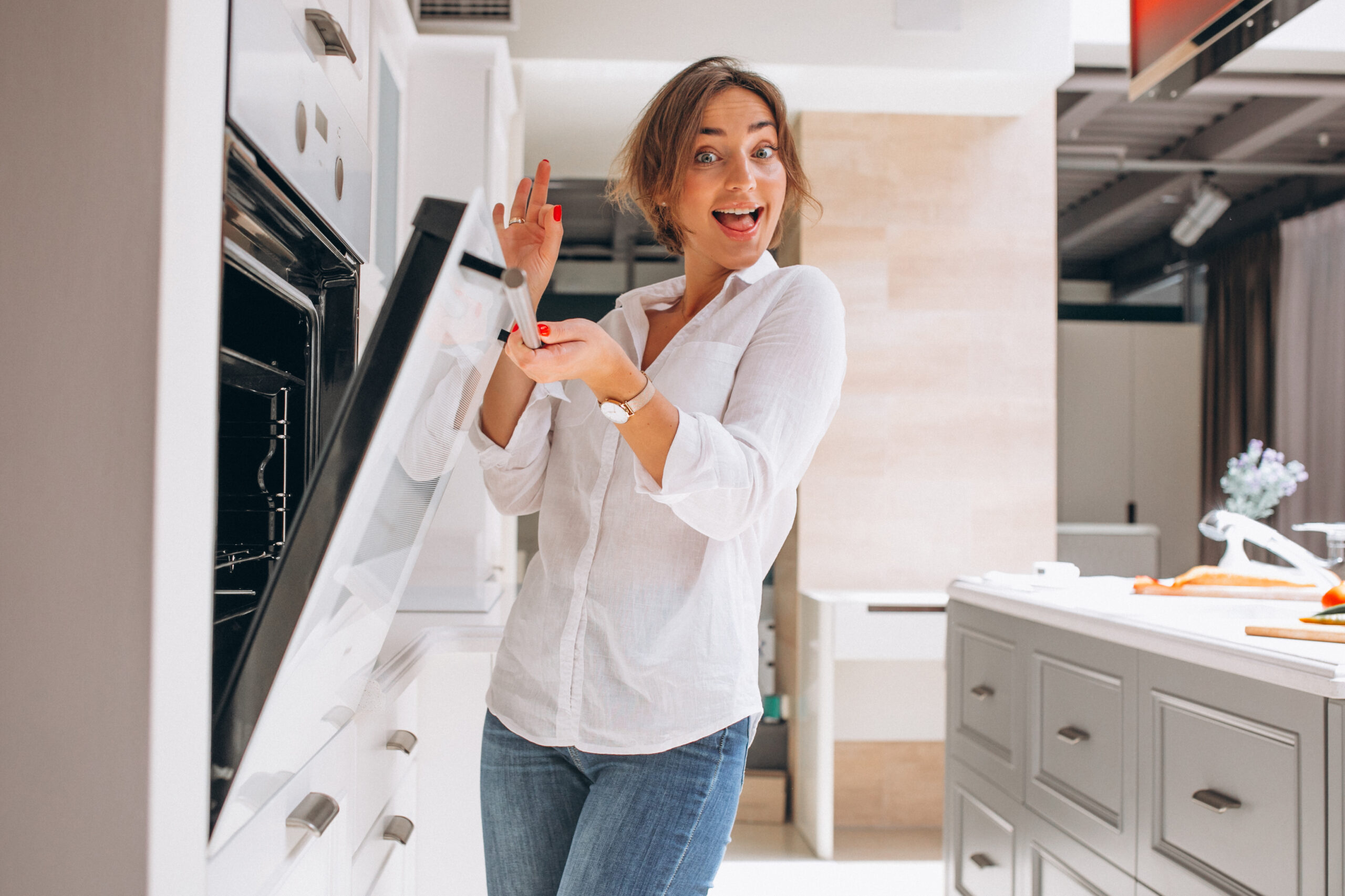 Woman Baking At Kitchen And Looking Into The Oven Woman Baking At Kitchen And Looking Into The Oven